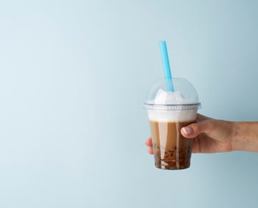 a person holding a cup of coffee in their hand