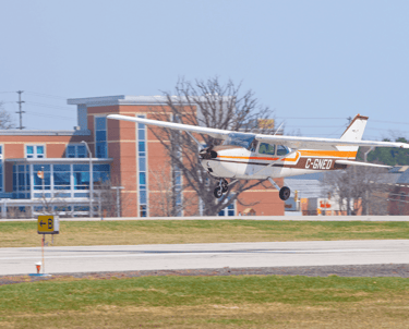 a small plane taking off from a runway