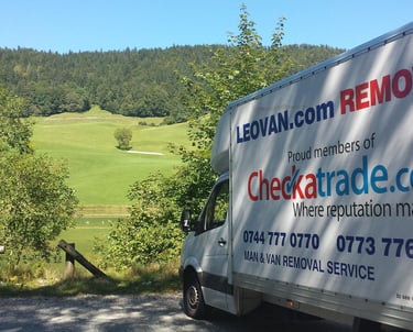 a removal truck with parked in front of a park in surrey