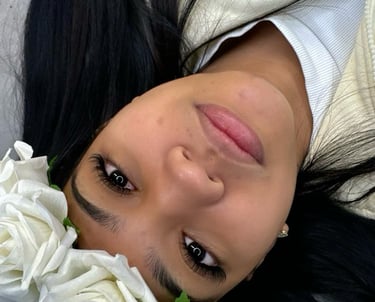a woman laying on a couch with flowers in her hair