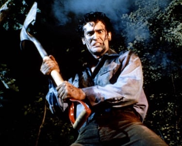 a man in a black shirt holding a hammer hammer and a large axe