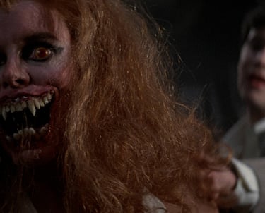 a man with a bloody face and a woman with a knife in her hand