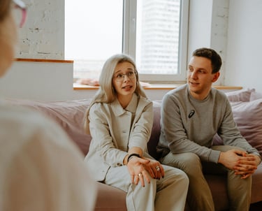 a man and woman sitting on a couch