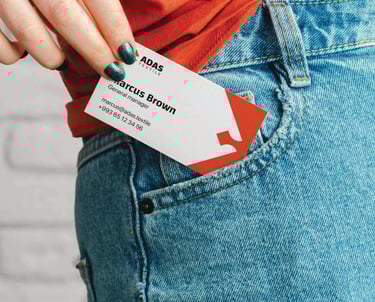 a woman's hand holding a business card