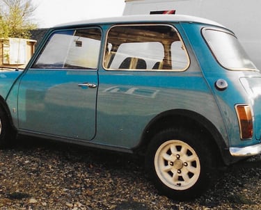a classic mark one surf blue Austin mini with a white roof