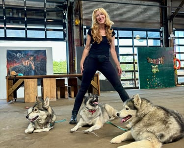 Trainer Julie standing in front of her three dogs