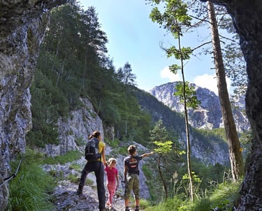 a group of people walking up a path in a cave