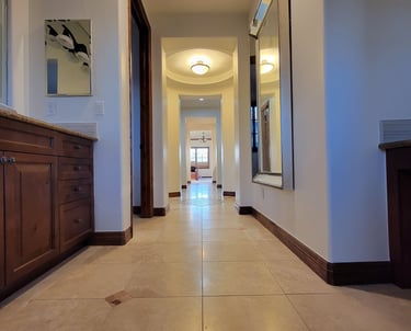a bathroom hallway with a mirror and a mirror