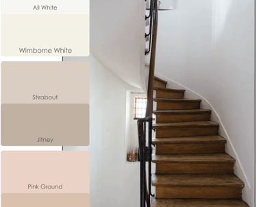 a staircase with a wooden staircase and a white wall