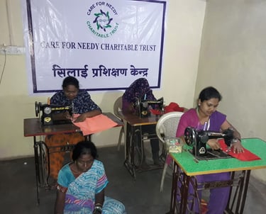 a group of women sitting at desks in a room stitching