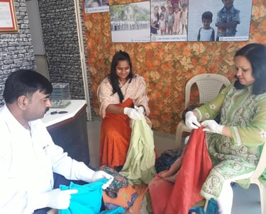Two women and a man sitting doing activity
