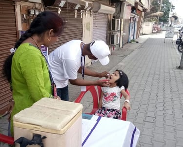 a woman and a man is giving a child vaccine