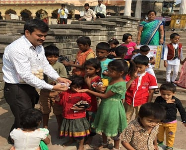 a man is giving a child a something to eat