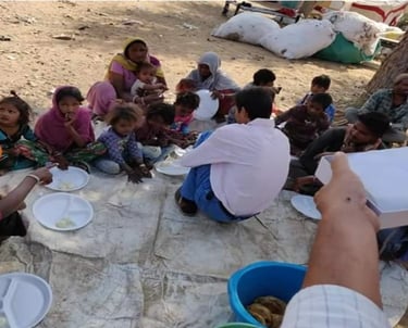 a group of people sitting around on the ground