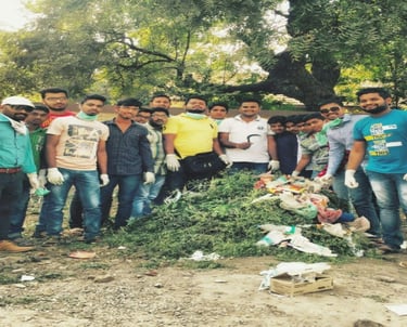 a group of people standing around a pile of garbage
