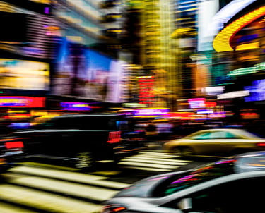 a city street scene with a car driving down the street
