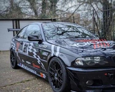 a black and white car with a graffiti on it