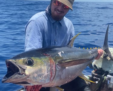 Angler holding a yellowfin tuna on a Catamaran Fishing Charter in Zanzibar