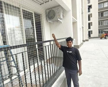 Close-up of durable pigeon safety nets installed on a balcony in Bangalore.