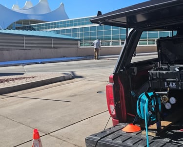 man doing leak detection on bridge at Denver international Airport