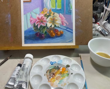 Gouache still life painting of lilies and fruit on an artist's easel with a paint palette.
