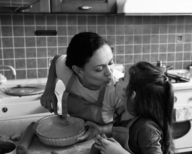 a hispanic woman and her daughter are in the kitchen