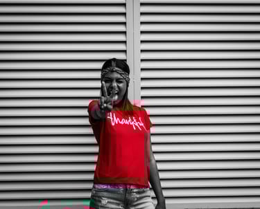 grayscale photo of a thankful college student in a red shirt doing the victory sign