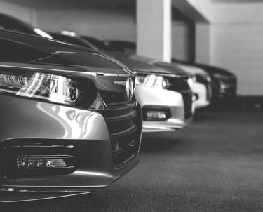 a row of parked cars in a parking lot
