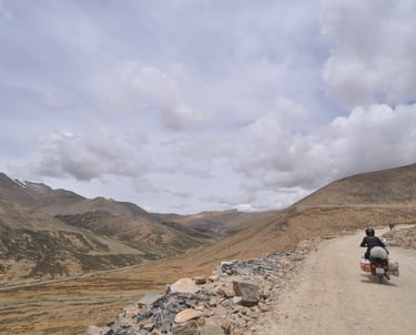 Tracey Billington riding the Leh to Manali highway over the great Himalayan range, Ladakh, India 