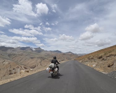Tracey Billington riding the Leh to Manali highway over the great Himalayan range, Ladakh, India 