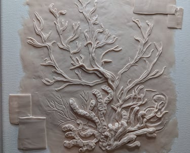 Polymer Clay relief sculpture on stretched canvas of a coral reef underway.