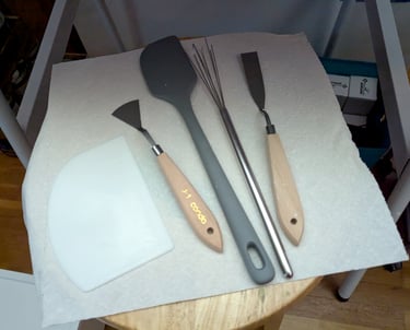 Artist's pallet knives, stainless steel wick, silicone spatula, and cake decorating tool make great 3D mural tools.