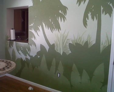 Green block colored mural of palm trees and undergrowth.