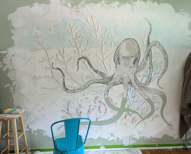 Interior relief mural using joint compound. Octopus in his garden. Sketching in colored pastels on the joint compound .