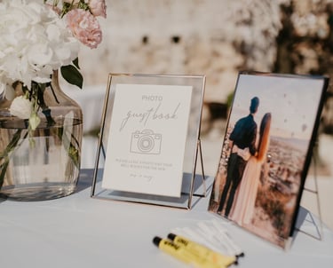 a table with a vase of flowers and a picture of a couple