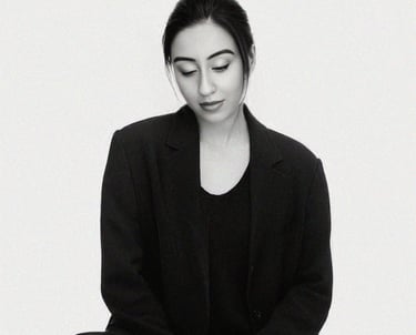 a wedding photoghrapher sitting on a stool with her eyes closed