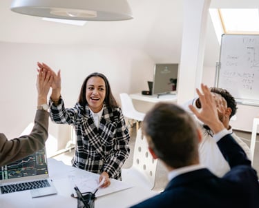 a woman is giving a high five to her team