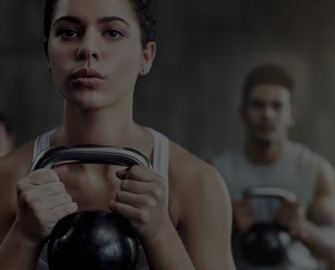 a woman squatting with a kettlebell. 