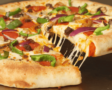 A picture of a big pizza with bell peppers, onions, pepperoni, and cheese.