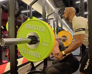a man is squatting on a bench with a green plate