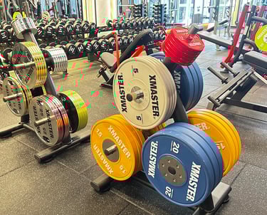 a gym room with a bunch of dumb dumbs and dumb dumbs