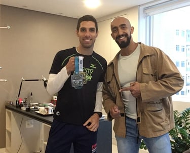 two men standing next to each other in a room