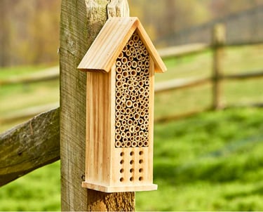 a birdhouse with a beehive and a beehive