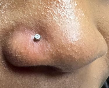 a close up of a nose piercing on a woman's nose