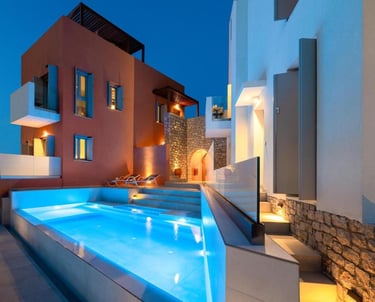 Luxury villa with illuminated infinity pool and modern architecture at twilight.