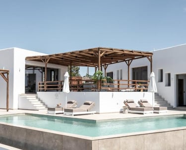 Luxury white modern villa with a private swimming pool and wooden pergola lounge area.