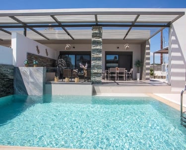 Modern luxury villa with a private swimming pool, outdoor dining area, and shaded pergola patio.