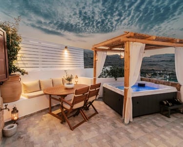 Luxury rooftop terrace with a private hot tub, wooden dining set, and scenic sunset views.
