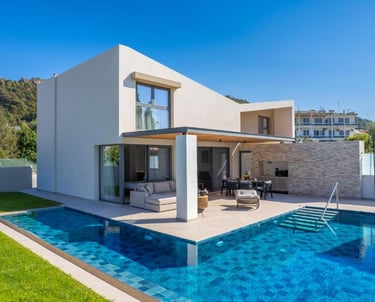 Modern luxury villa with a private turquoise swimming pool and outdoor lounge patio.