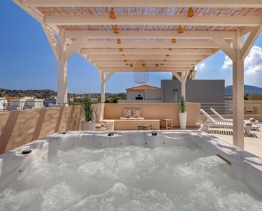 Luxury rooftop terrace with bubbling hot tub, wooden pergola, and scenic city views.